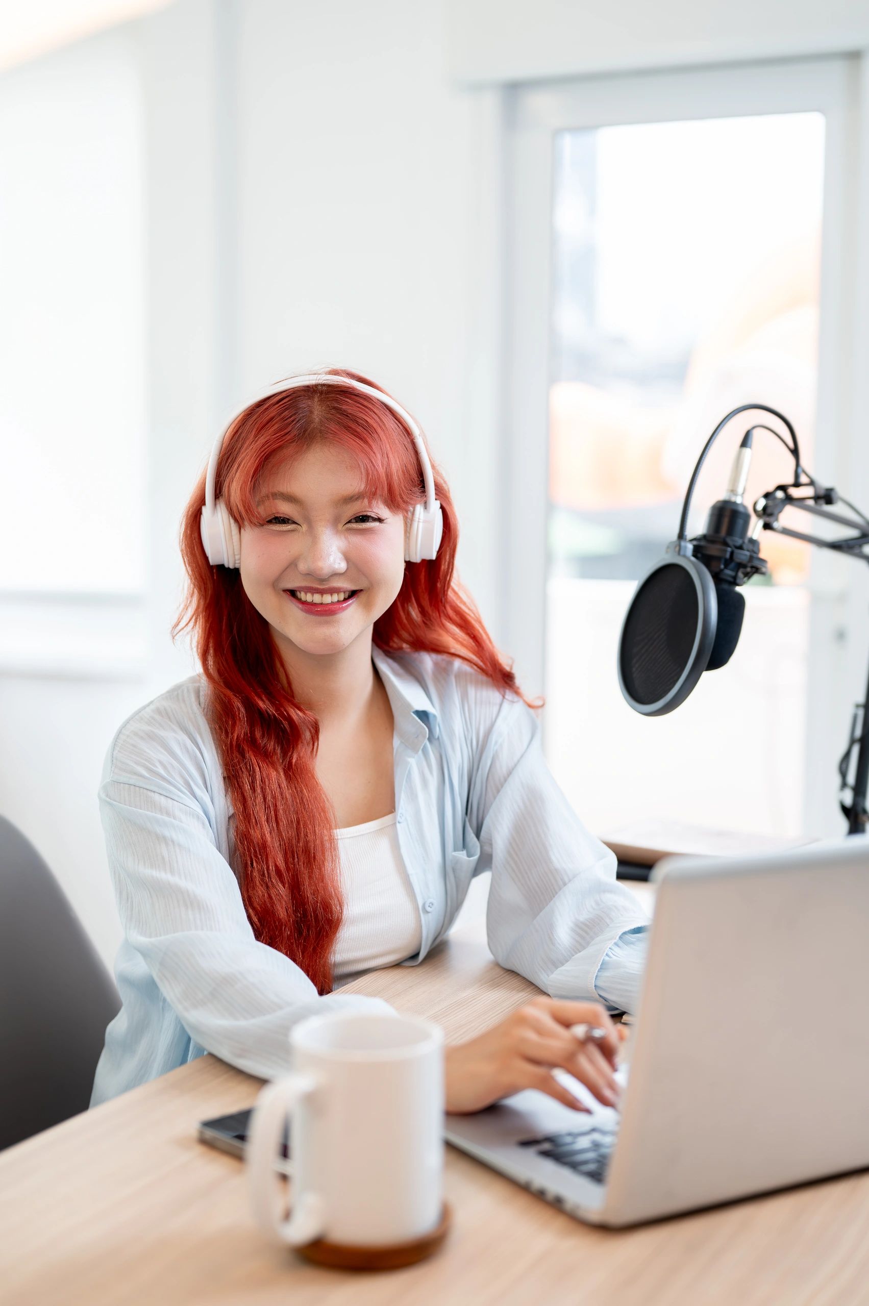 Content creator smiling at a computer workstation